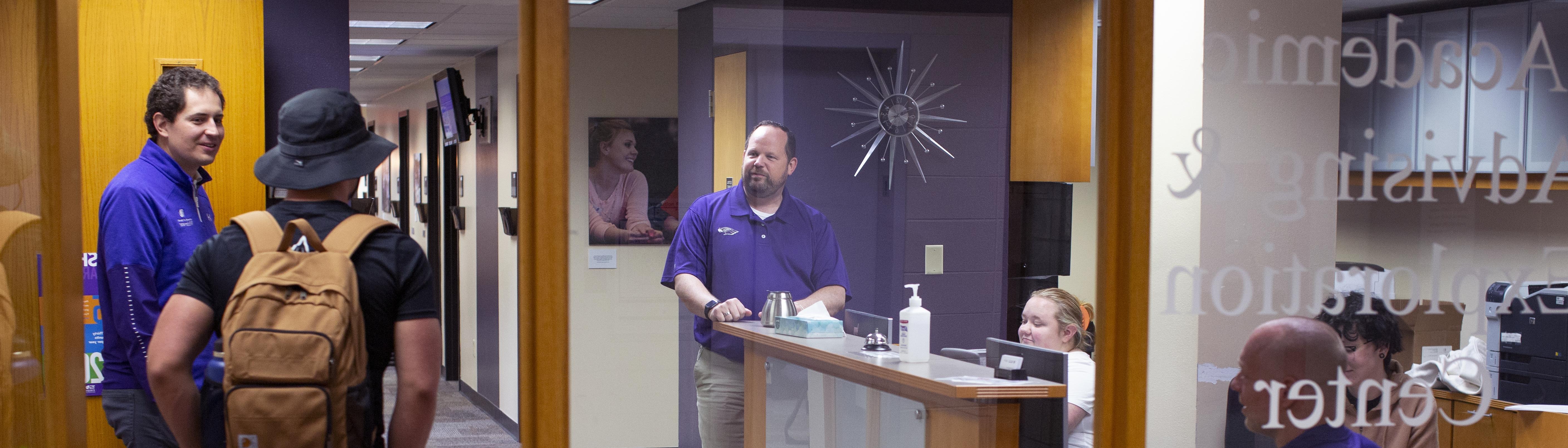 Students and staff talking in academic advising and exploration center