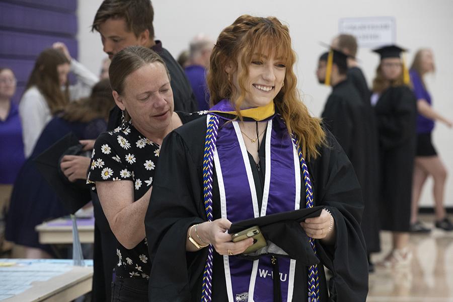 A social work student smiles at Commencement.