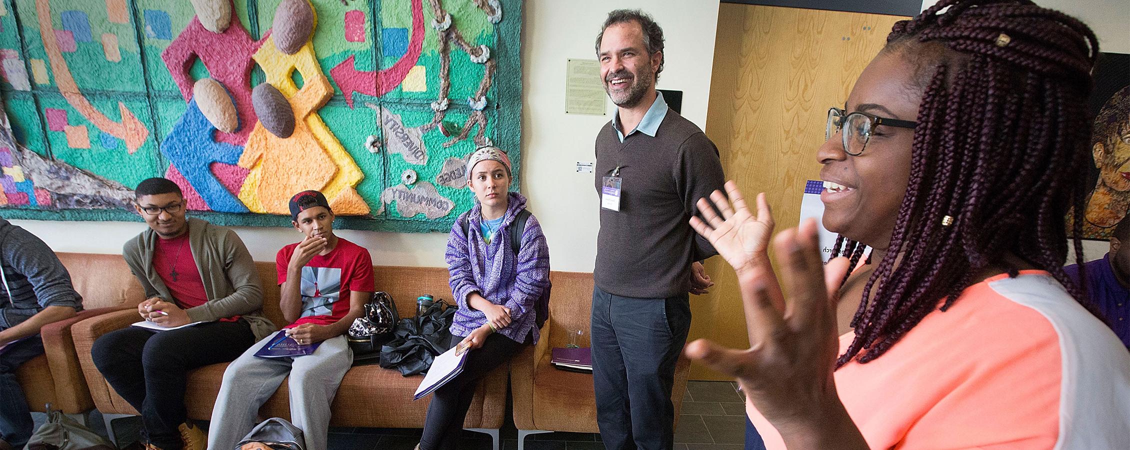 Middle school teacher stands in class as student speaks