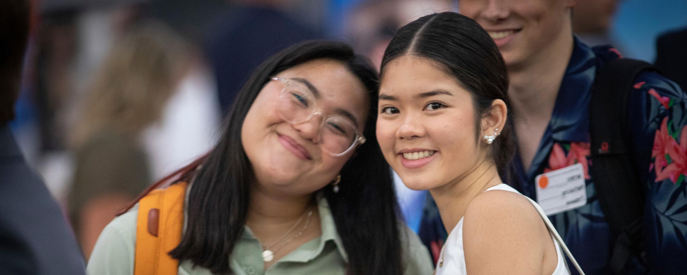 Two women smiling at a recruitment fair