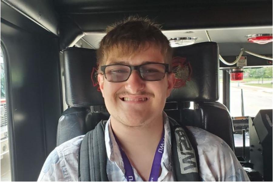 LIFE student smiling during a car ride.