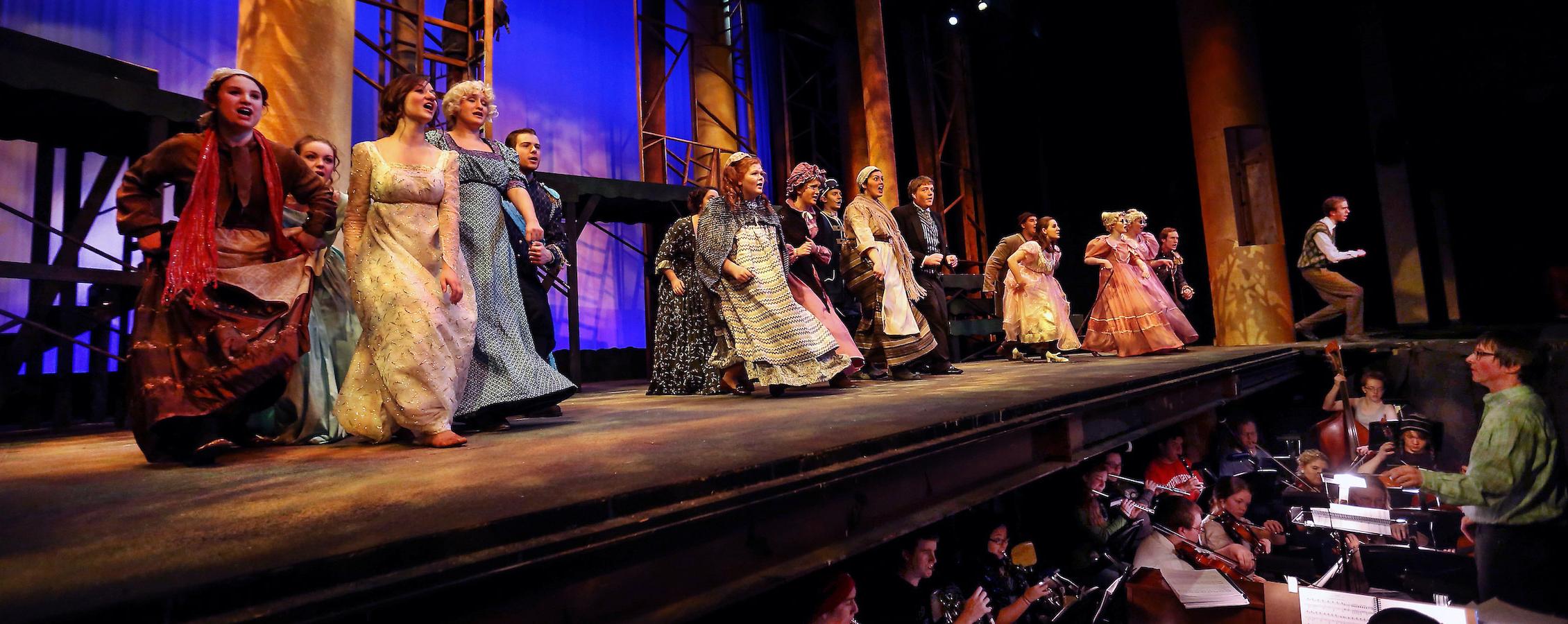 Whitewater students sing at end of stage in Barnett Theatre