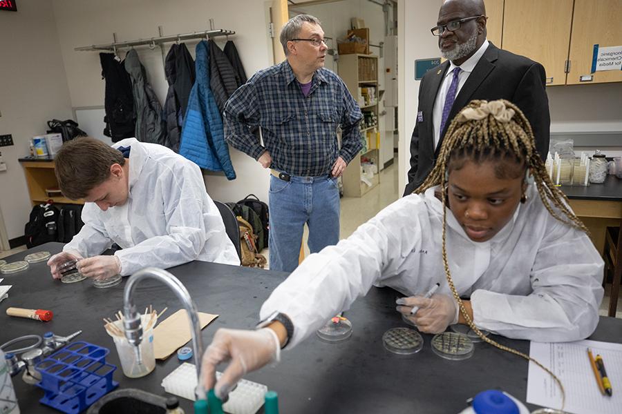 An international student works in a science lab.