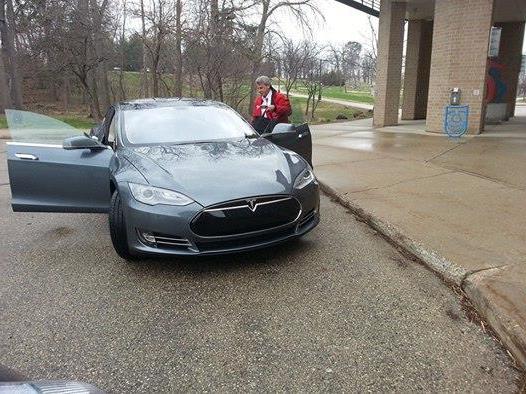 Man looking at a Tesla vehicle