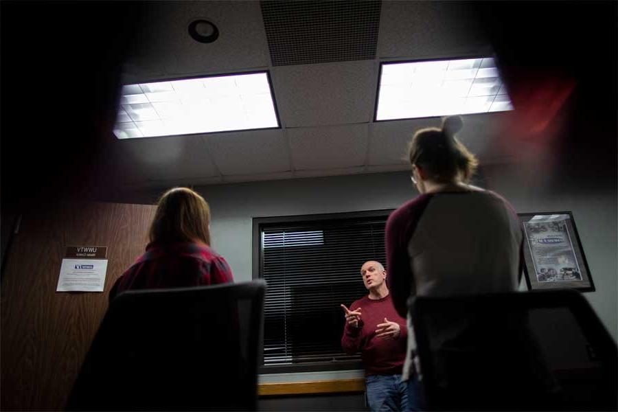 Jim Mead briefs two students in the Andersen Library studio.