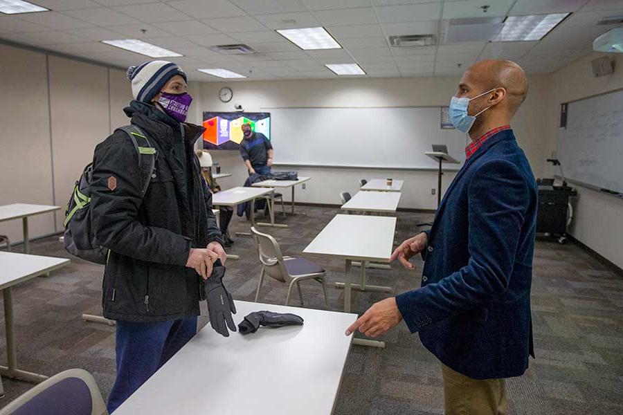 Logan Edwards talks with a student.