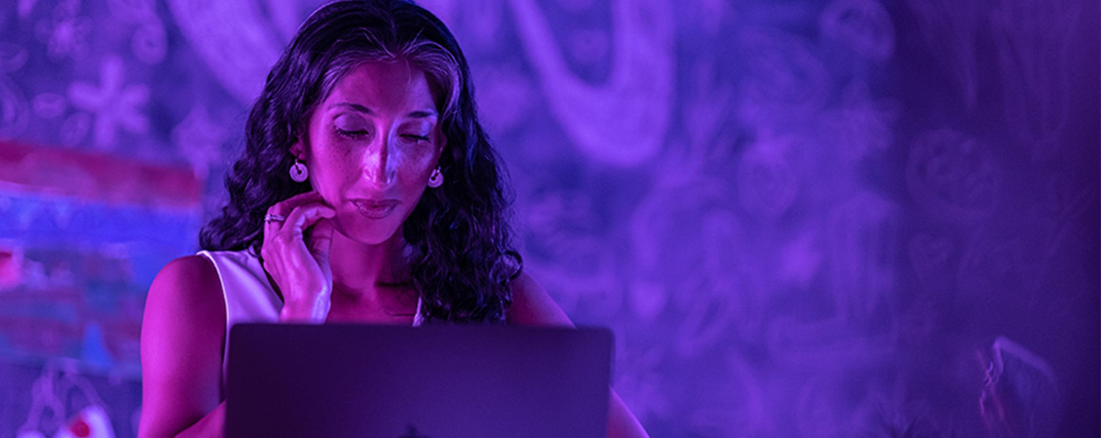 Woman sitting at monitor taking online college class